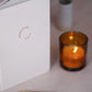The Archely's Habitual Self Journal beside a candle, styled for a peaceful journaling moment